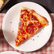 Fresh cheese pizza served on a white plate